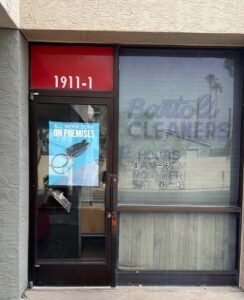 “All work done on premises” sign on the door at Bartoli Cleaners in Mesa, Arizona