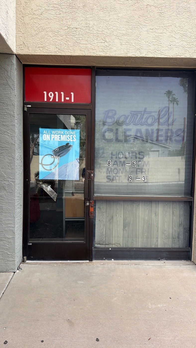 “All work done on premises” sign on the door at Bartoli Cleaners in Mesa, Arizona
